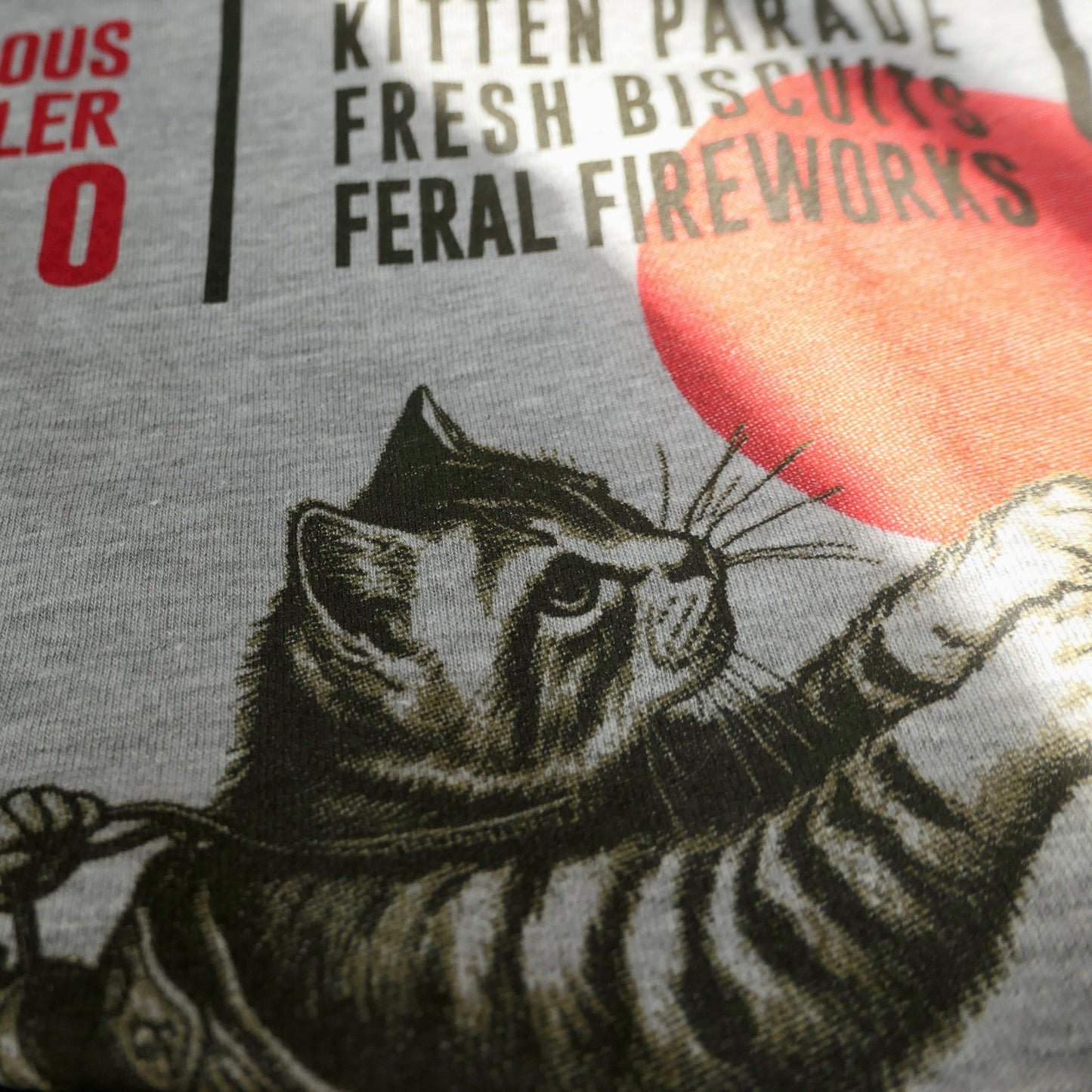 Cat-themed t-shirt with cowboy graphic and text on a gray background