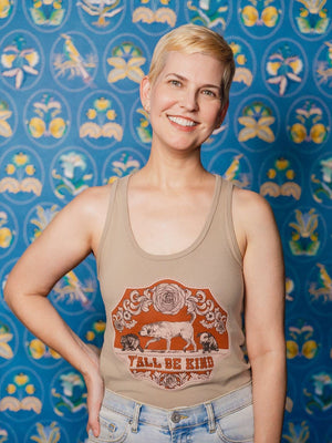 A Woman wearing a Y'all Be Kind Tank Top in front of a patterned background