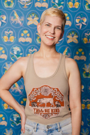 A Woman wearing a Y'all Be Kind Tank Top in front of a patterned background