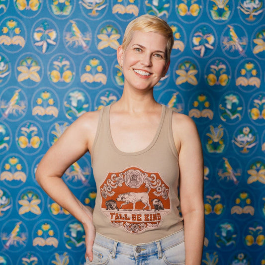 A Woman wearing a Y'all Be Kind Tank Top in front of a patterned background