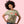 Woman wearing a graphic t-shirt with a cat and text design on a pink background