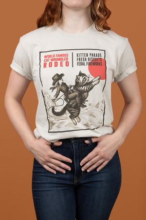 Close up photo of a woman wearing a Cat Wrangler Rodeo T-shirt