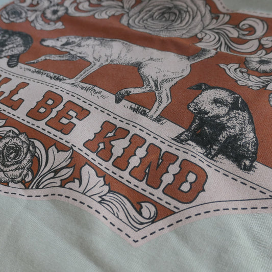 Detailed close up of Y'all Be Kind illustration on a t-shirt