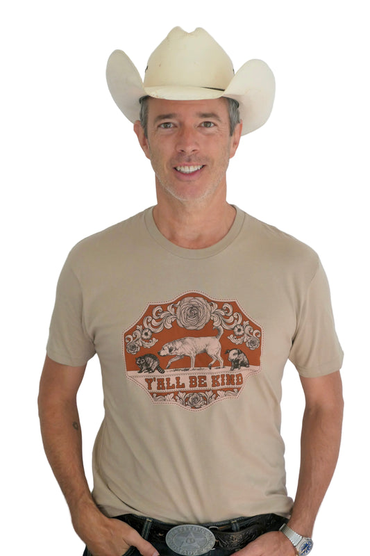 Man wearing a cowboy hat and a tan t-shirt with that says Y'all Be Kind
