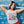 Woman wearing a 'Chihuahua Extra Spicy' t-shirt against a colorful patterned background