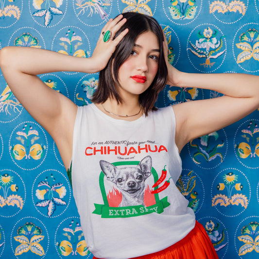 Woman wearing a 'Chihuahua Extra Spicy' t-shirt against a colorful patterned background