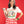 A Woman holds a chihuahua while wearing Pet Rodeo's Spicy Chihuahua t-shirt in front of a red background
