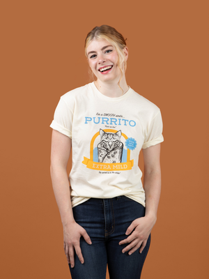 A woman wearing Pet Rodeo's Purrito Cat T-shirt in front of a brown background
