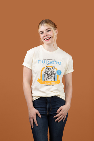 A woman wearing Pet Rodeo's Purrito Cat T-shirt in front of a brown background