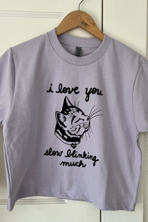 Lavender Boxy T-shirt with a cat print that says I love you slow blinking much