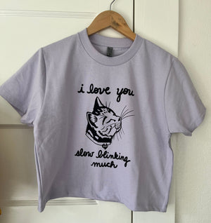 Lavender Boxy T-shirt with a cat print that says I love you slow blinking much