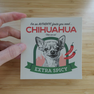 someone holding a 4 inch, Spicy Chihuahua vinyl sticker against a wooden background