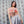 Woman wearing a Cat Wrangler Rodeo Tank Top against a patterned background
