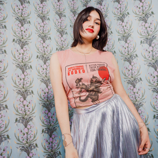 Woman wearing a Cat Wrangler Rodeo Tank Top against a patterned background