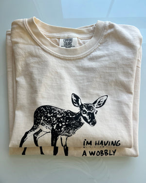 Two t-shirts in a stack with a baby deer graphic