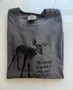 Folded grey t-shirt with artwork of a cute baby deer